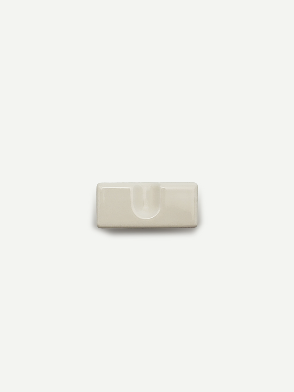 Minimal rectangle knobs in white for bathroom vanity drawers and cabinets.