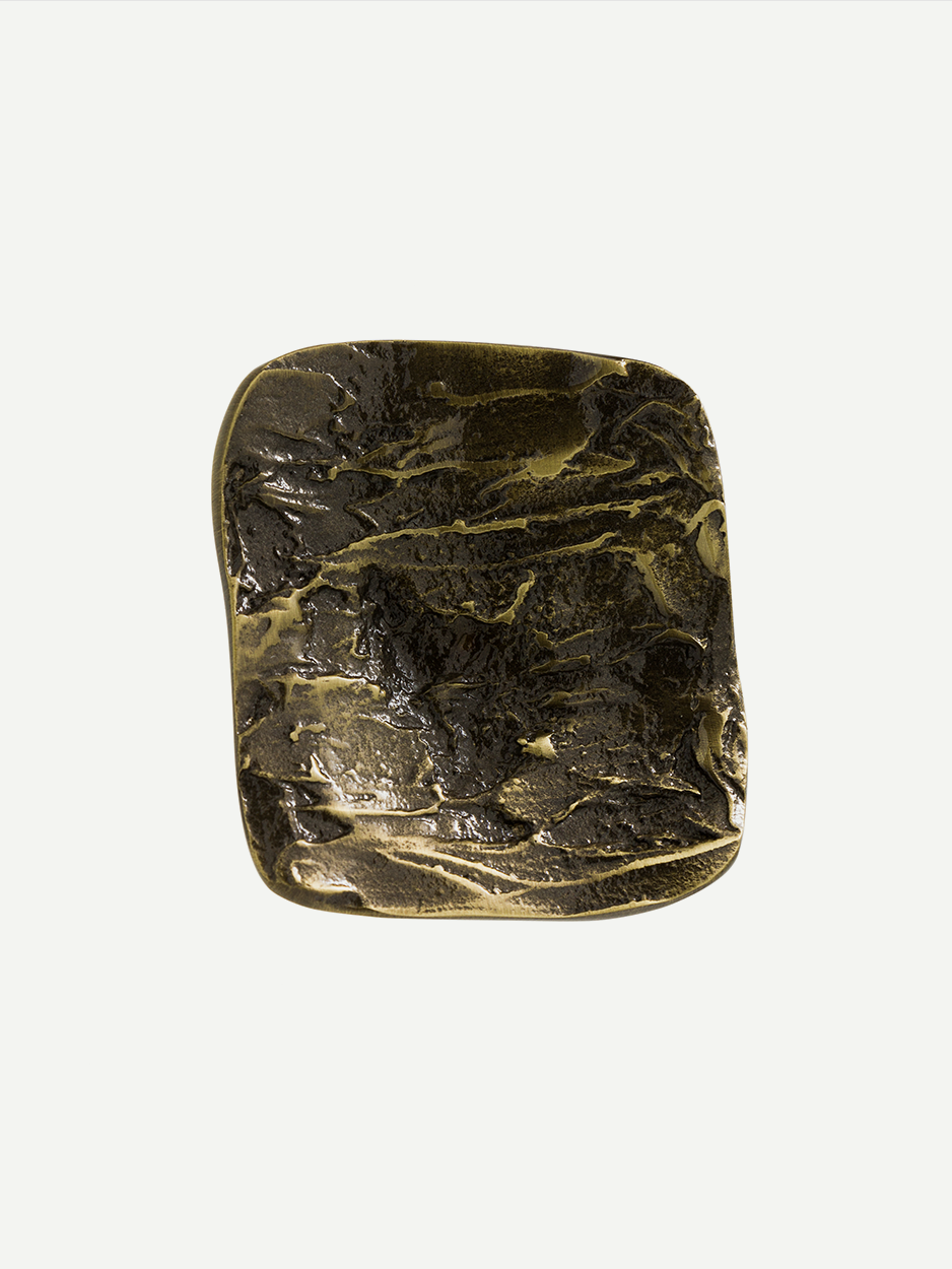 Minimalist textured brass pulls for modern vanity cabinets.